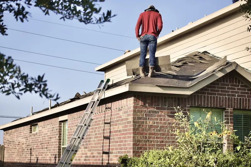 Professional roofer working on a residential roof in Bayport